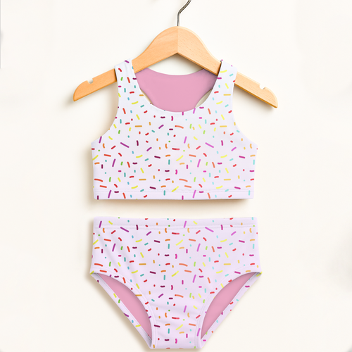 Pastel pink and white sprinkle-patterned two-piece swimsuit for girls with halter top and high-waisted double-layered upf 50+ design