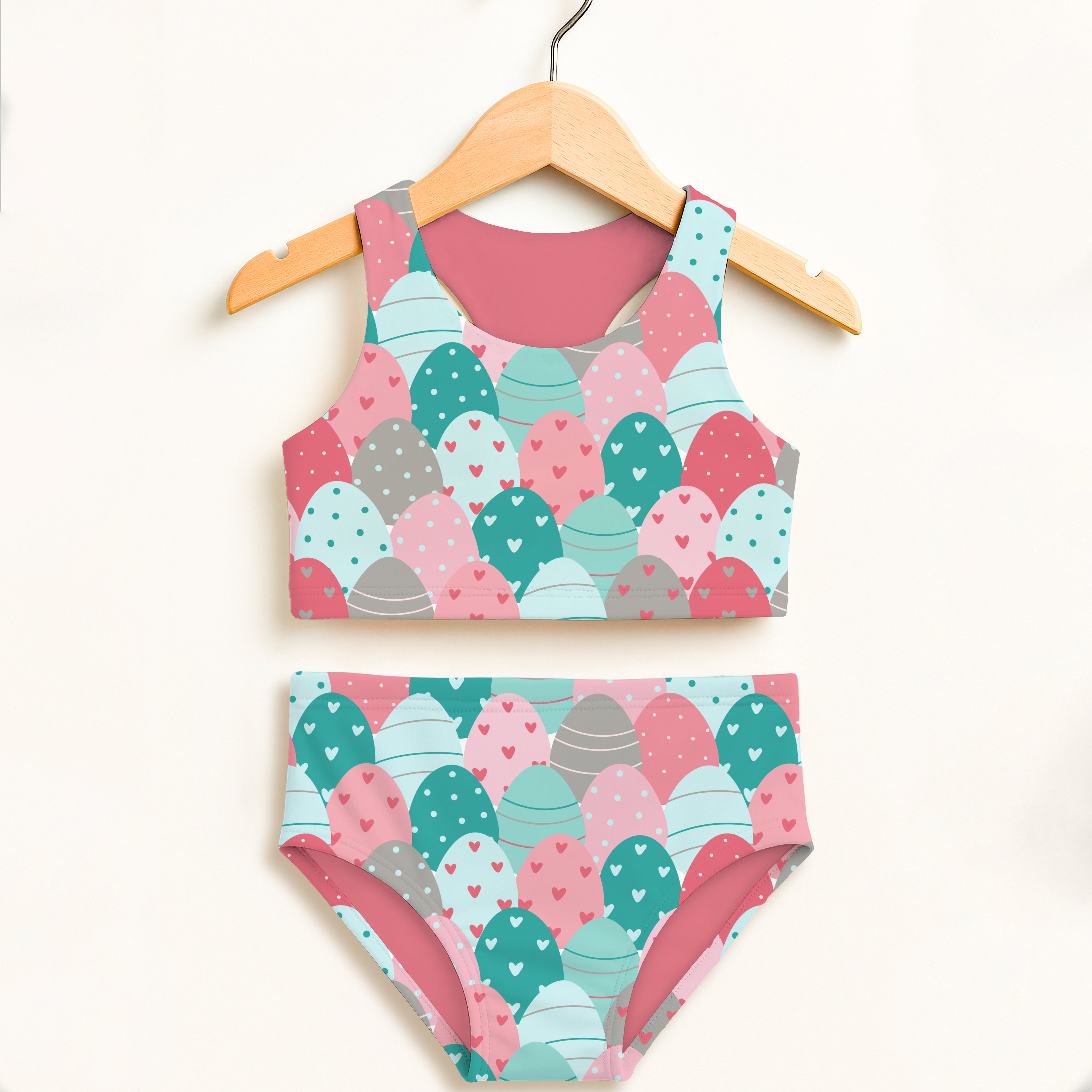 Girls stacked easter eggs two piece swimsuit in pastel pink teal and gray with playful egg pattern and upf 50+ protection