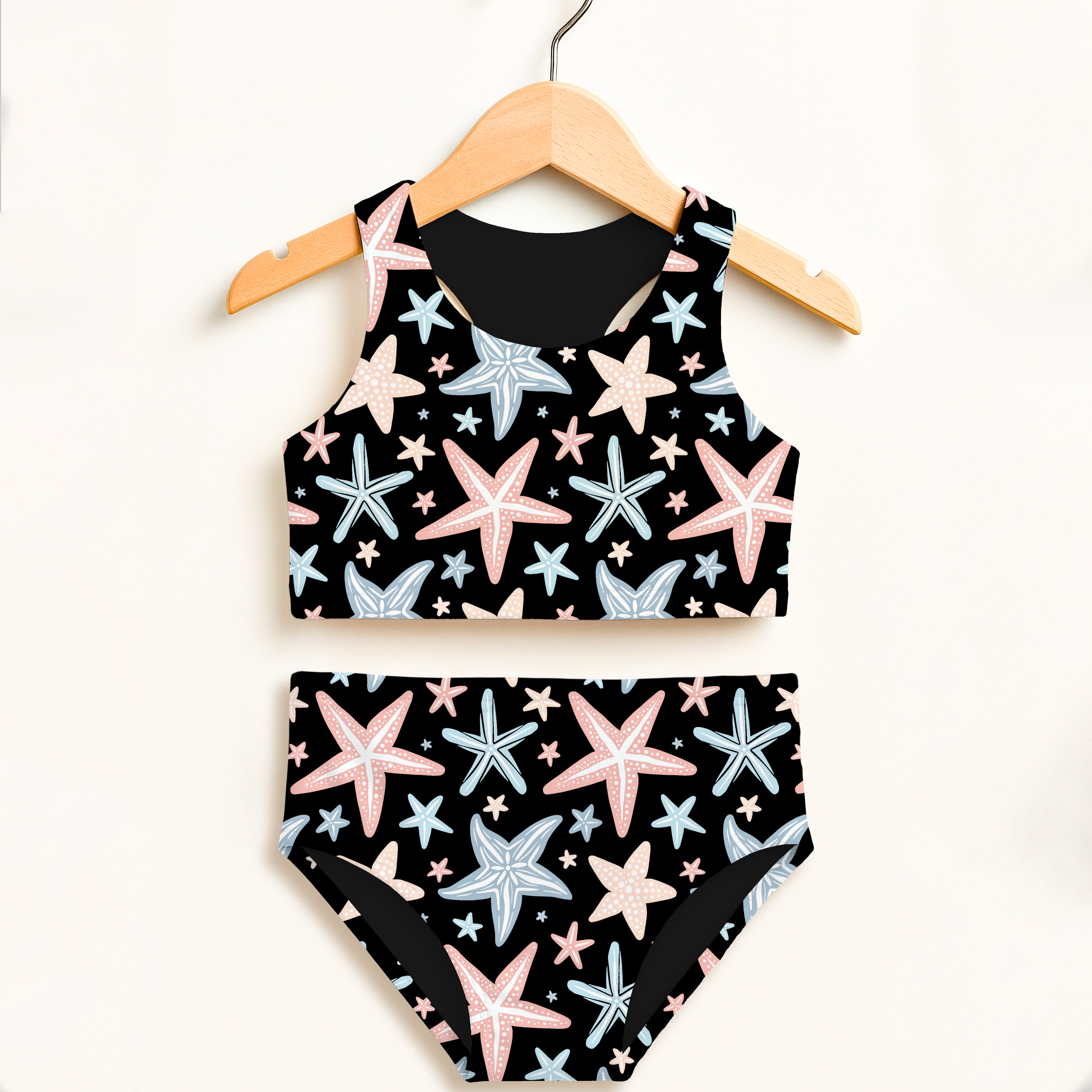 Girls pastel starfish two piece swimsuit with black fabric pink and light blue starfish patterns high waisted comfort