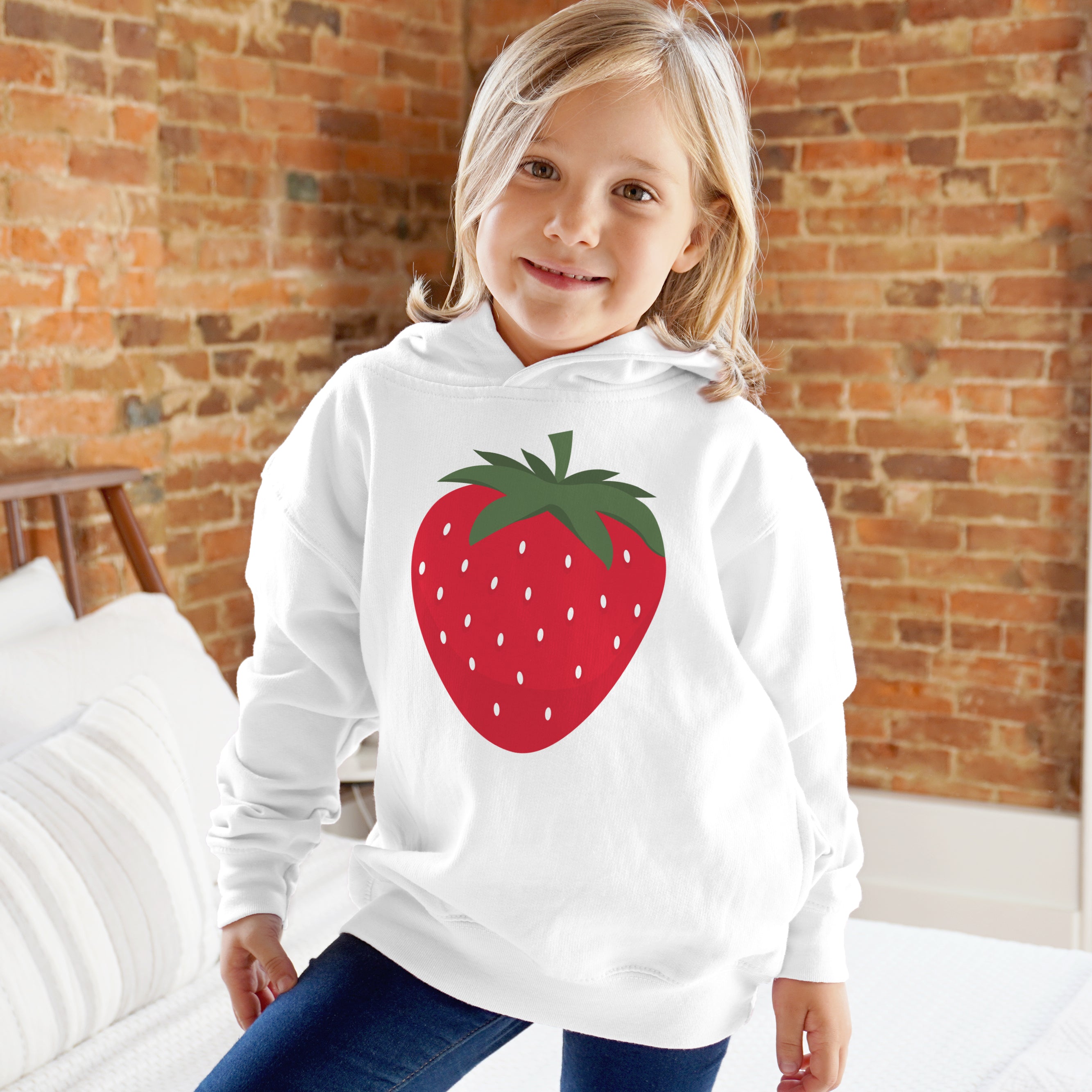 Kids white hoodie featuring a large red strawberry graphic with green leaves and white seed details