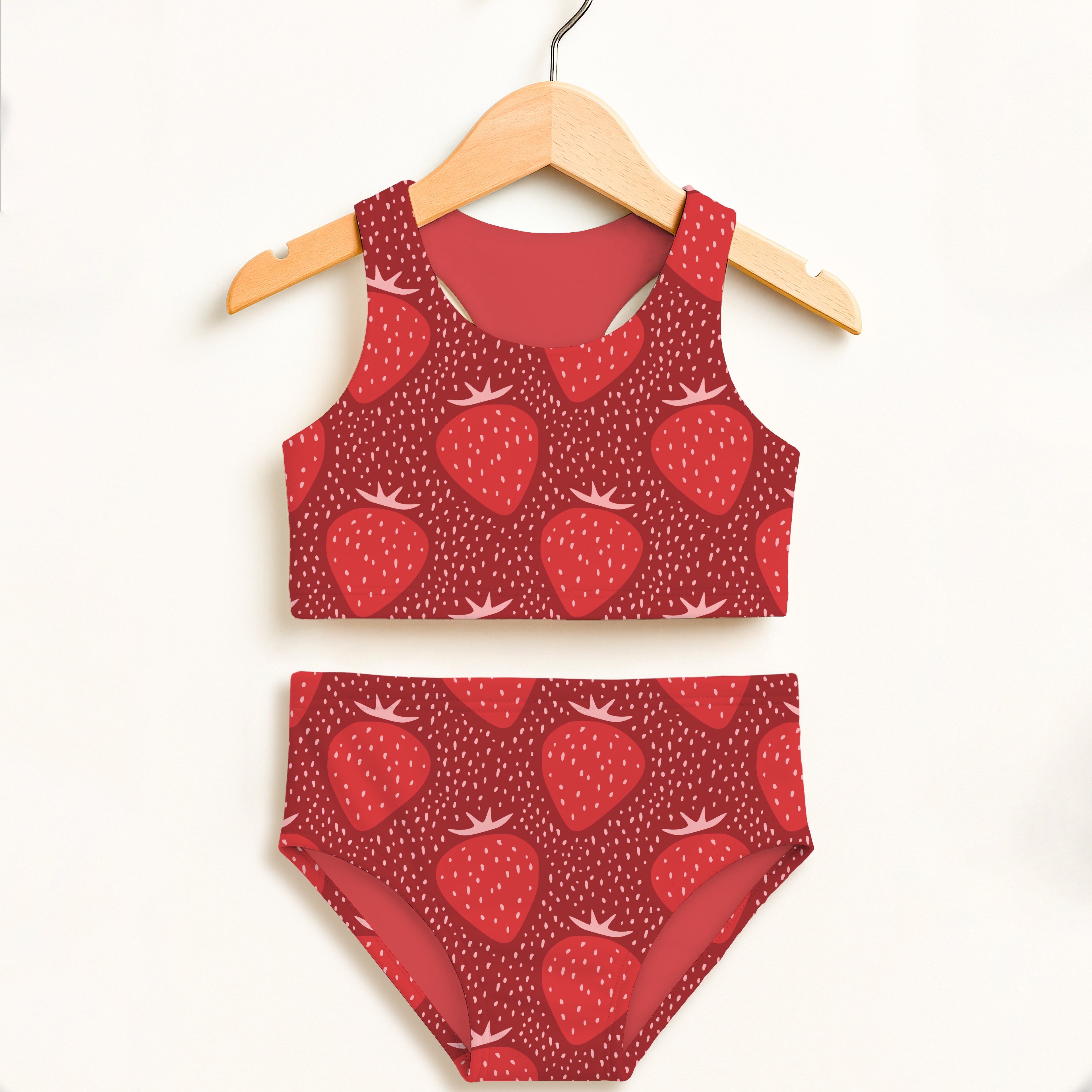 Red strawberry-patterned girls two-piece swimsuit hanging on wooden hanger double layered upf 50+ high waisted comfort