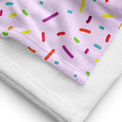 A soft lavender girls colorful sprinkles towel with a playful multicolored sprinkle pattern for kids
