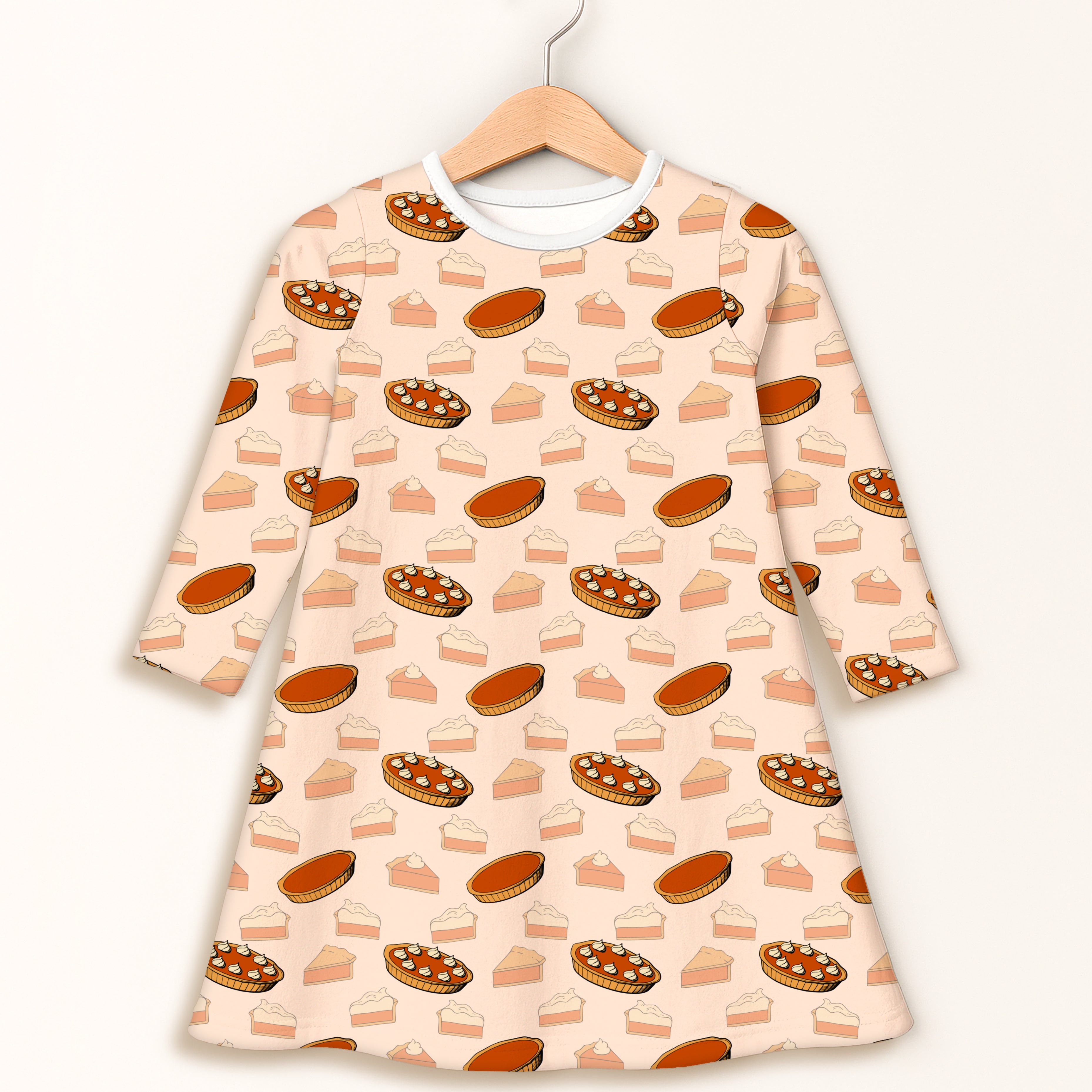 Girls pumpkin pie Thanksgiving long sleeve peach dress with playful cartoon pie print in orange and brown shades