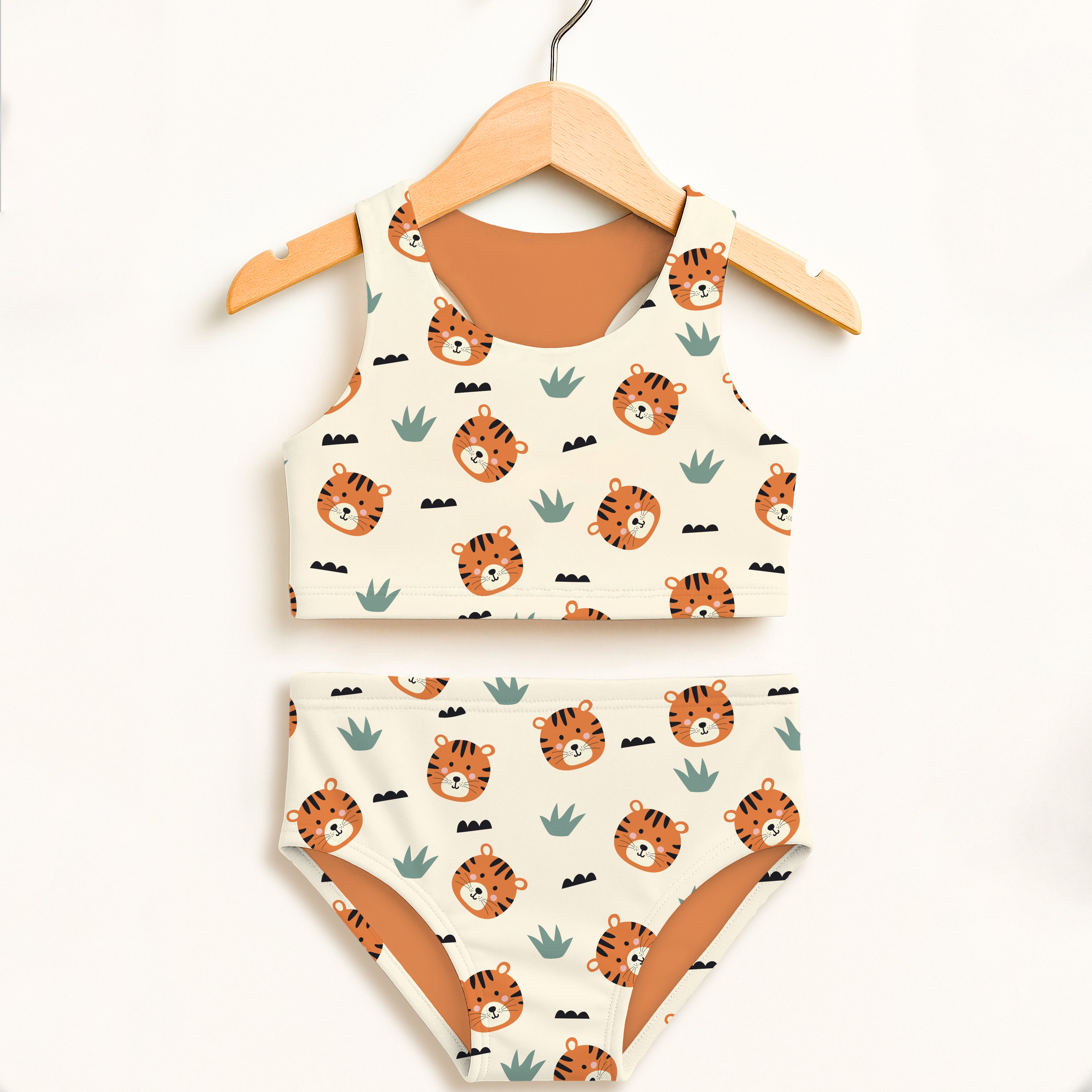 Girls tiger two piece swimsuit with white base orange tiger faces green cactus patterns tan lining and upf 50 plus comfort