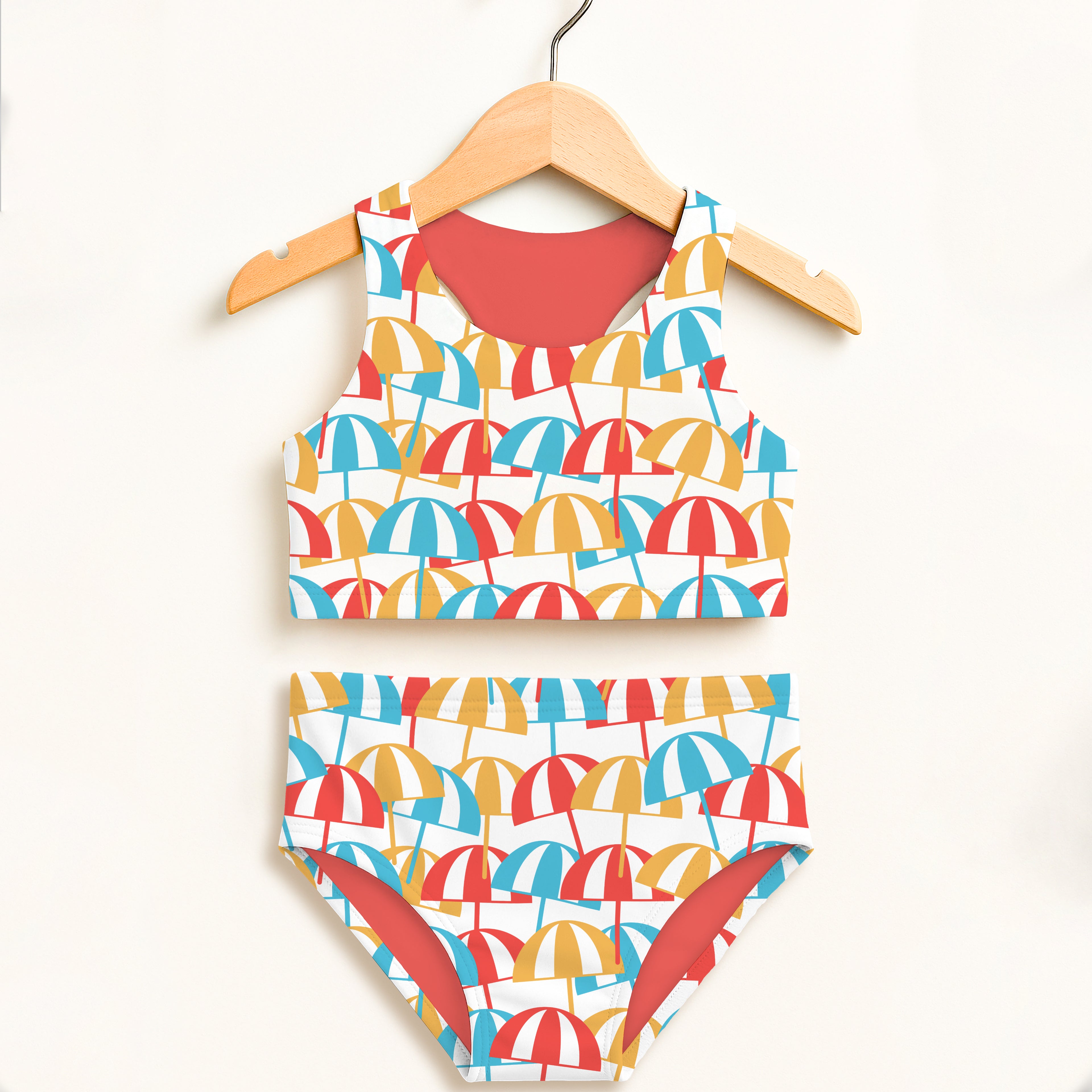 Girls beach umbrella two piece swimsuit with red blue yellow umbrella pattern and coral side panels upf 50 plus comfort