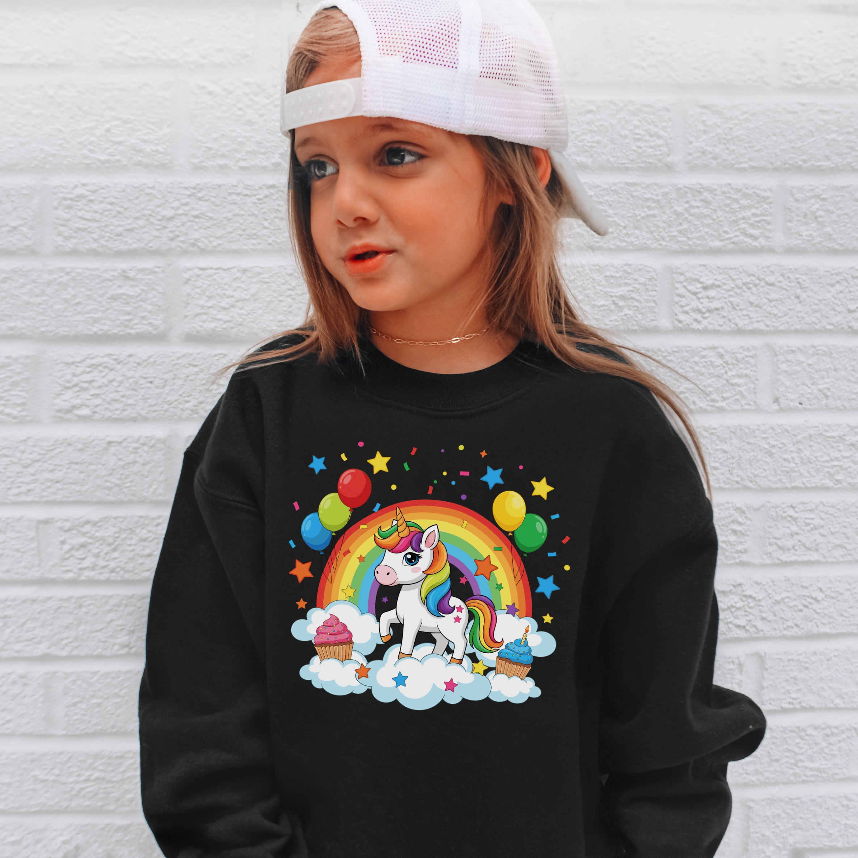 Black girls long-sleeved sweatshirt featuring a colorful unicorn with rainbow mane surrounded by balloons cupcakes and stars