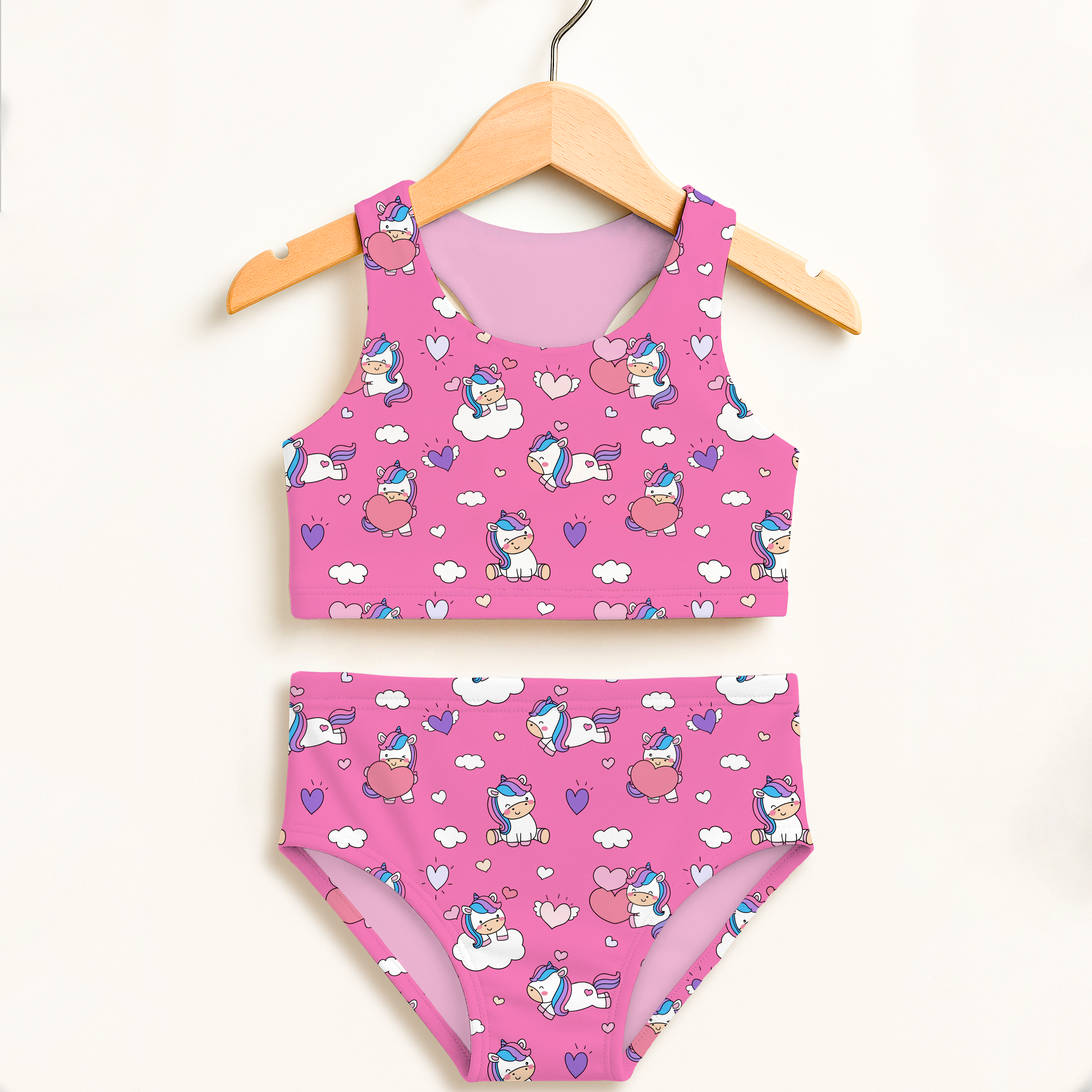 Girls unicorn hearts two piece swimsuit in vibrant pink with cartoon unicorns hearts clouds and double layered upf 50+ material