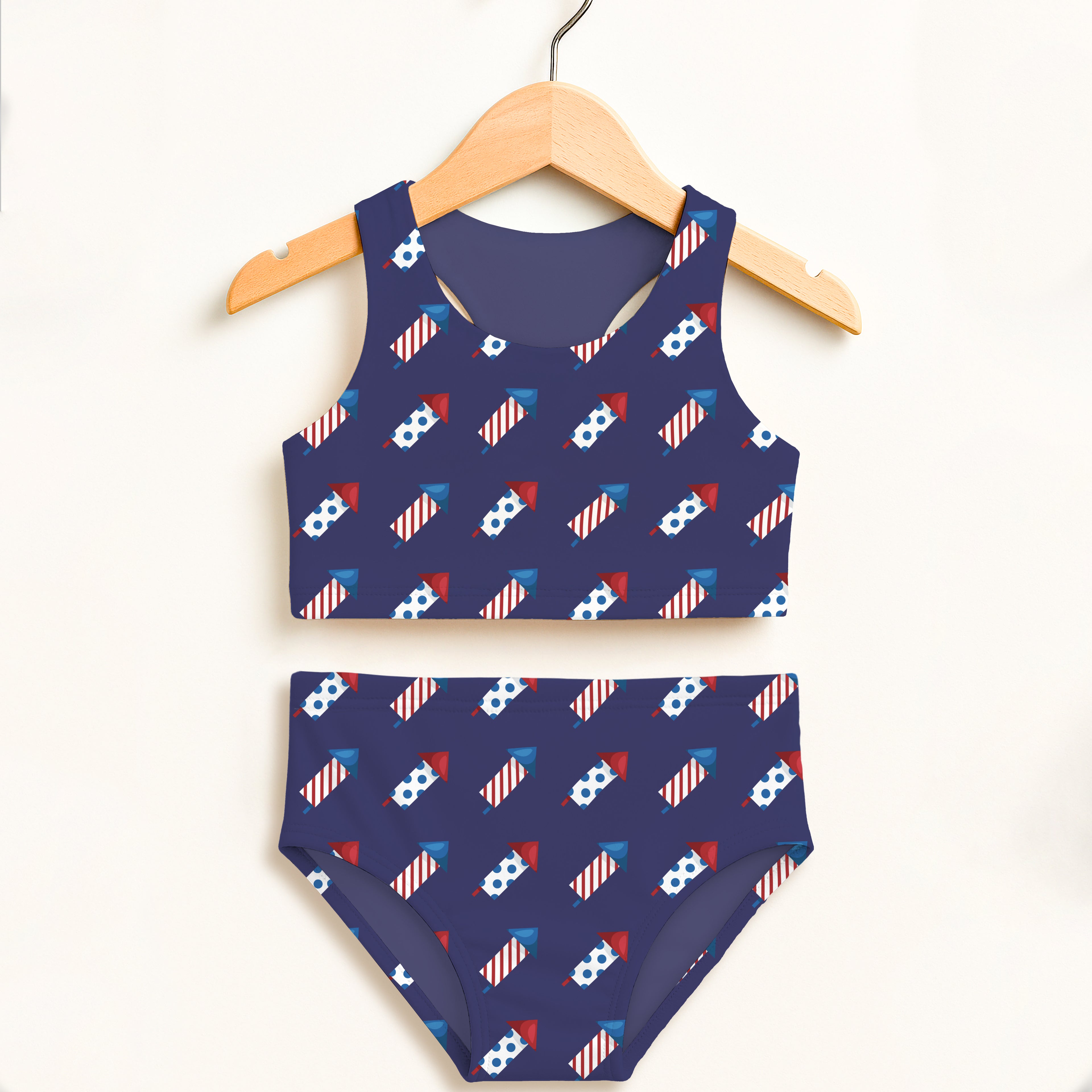 Girls fireworks rockets navy blue two-piece swimsuit with playful rocket and flag pattern double layered upf 50 high waisted