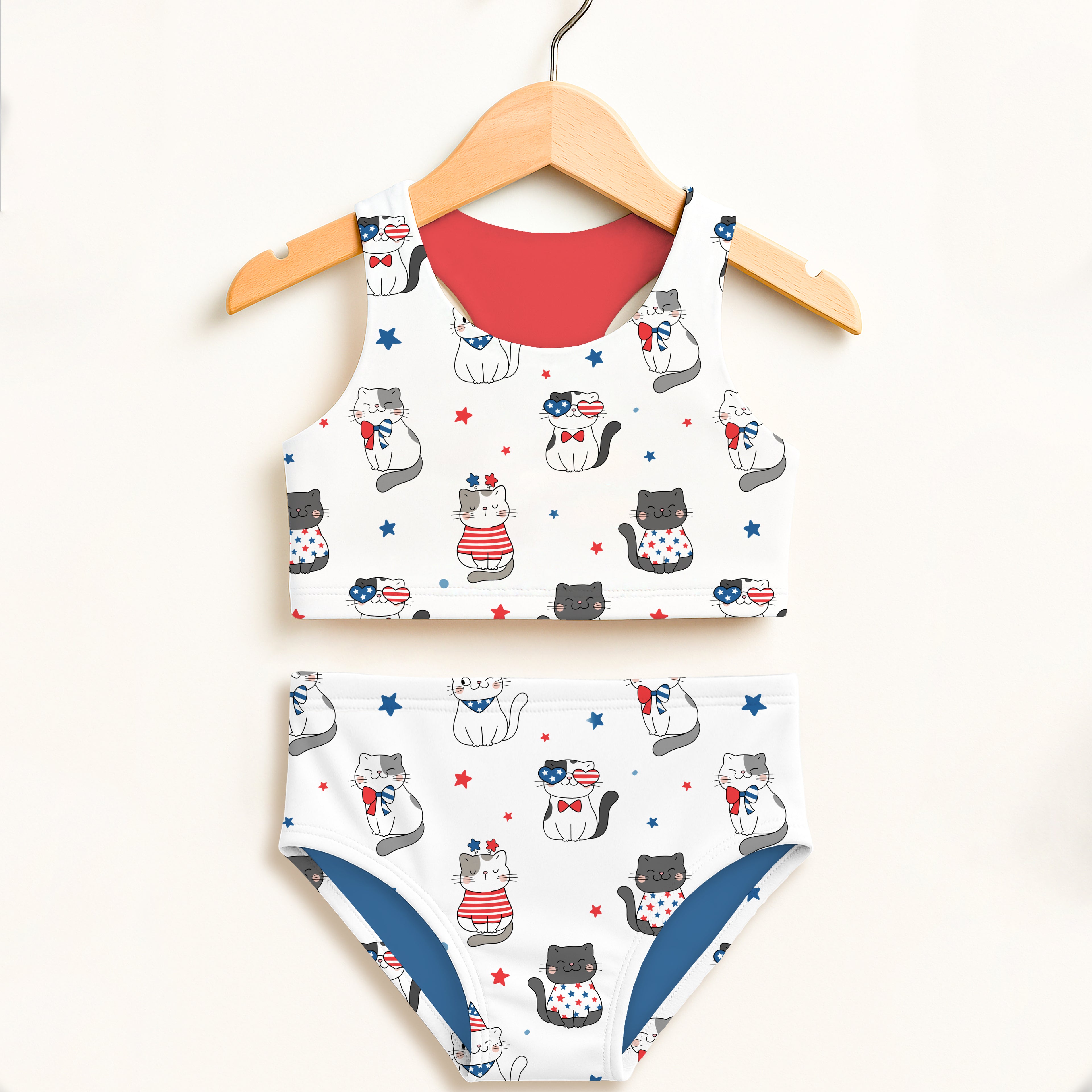 White girls patriotic cat two piece swimsuit with red and blue accents featuring cartoon cats and stars on fabric
