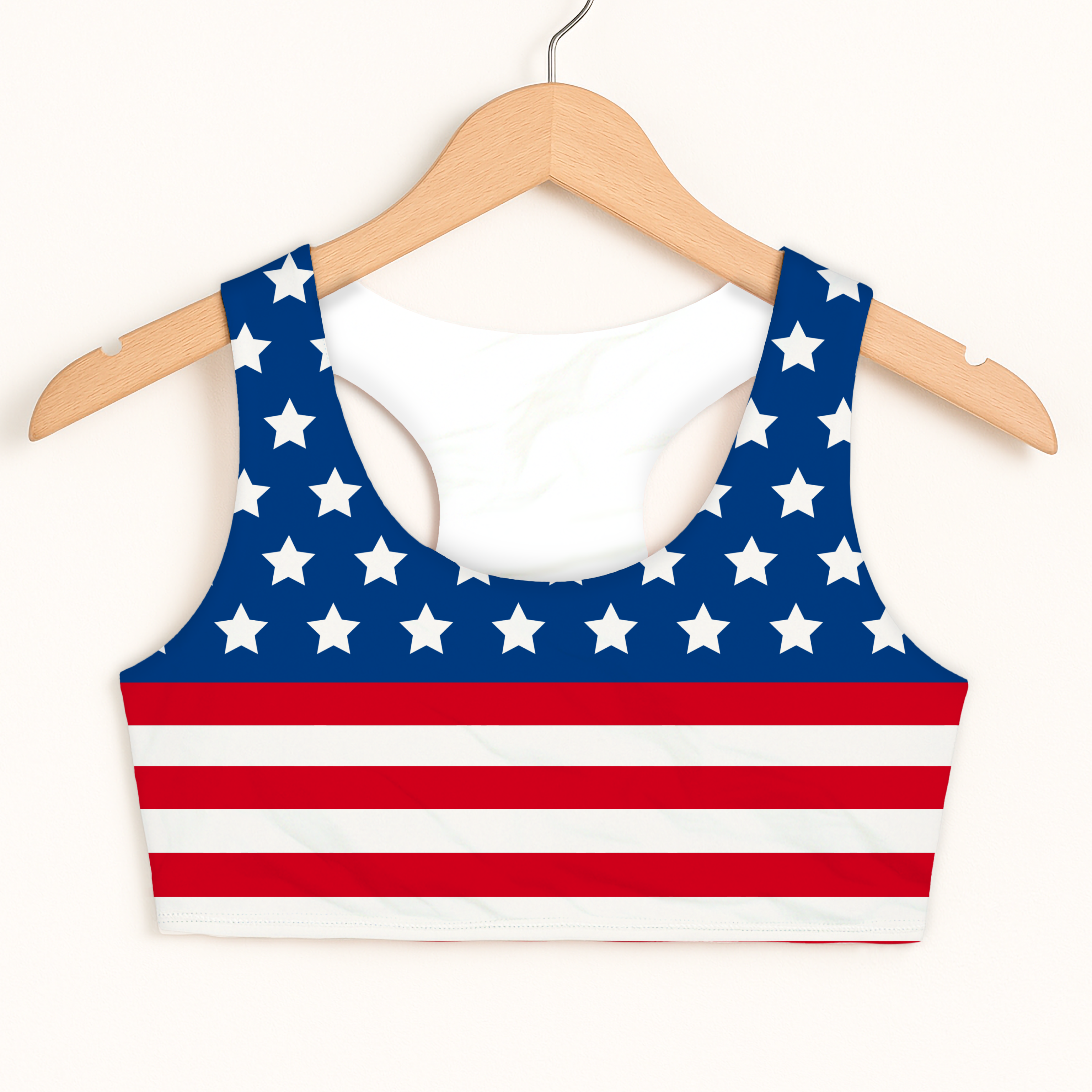 Girls american flag sports bra in blue and red with white stars and stripes quick drying double layered comfort hanging on wooden hanger