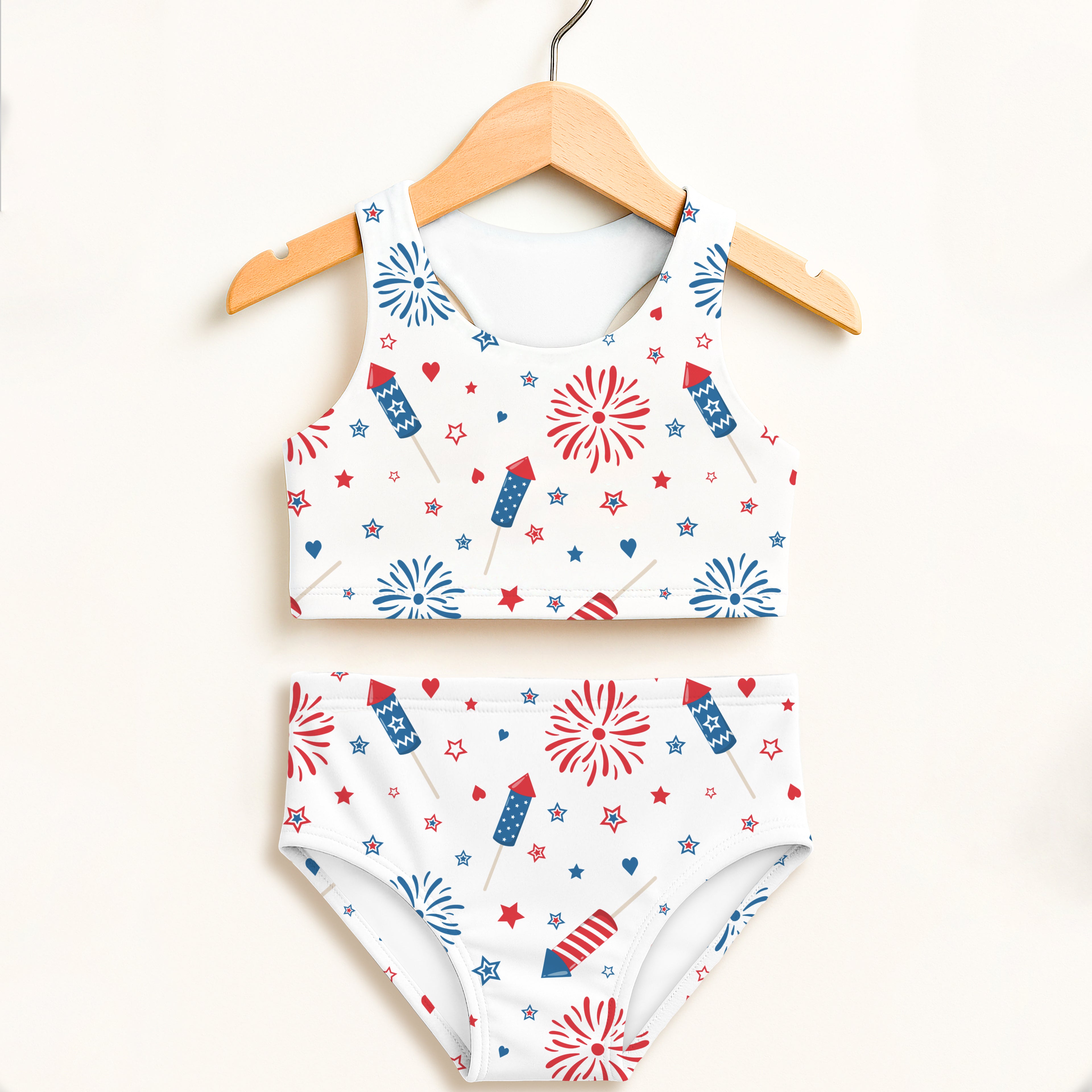 White girls patriotic fireworks two piece swimsuit with halter top and high waisted bottoms featuring red white and blue rockets