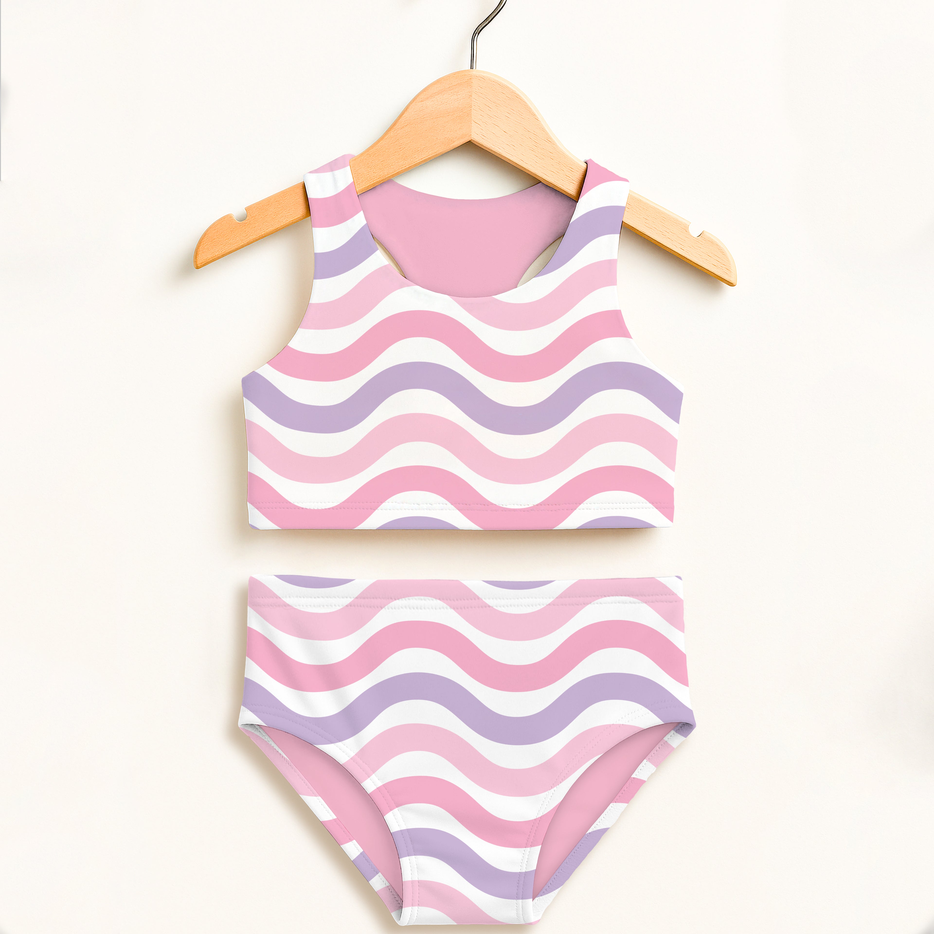 Girls pink wavy two piece swimsuit with halter top and high waisted bottoms featuring UPF 50 plus comfort