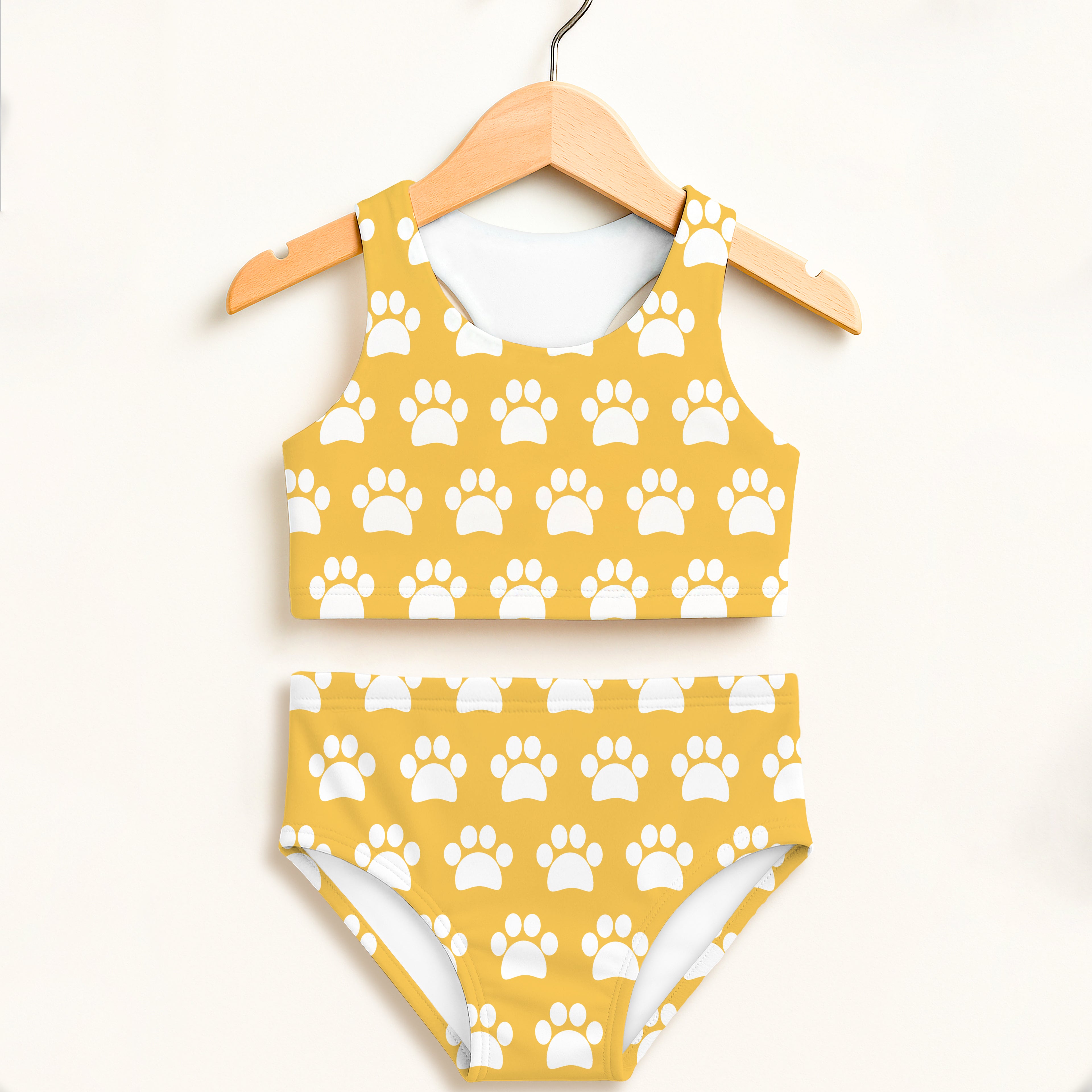 Girls yellow paw print two piece swimsuit with halter top high waisted bottoms and upf 50 plus double layered fabric
