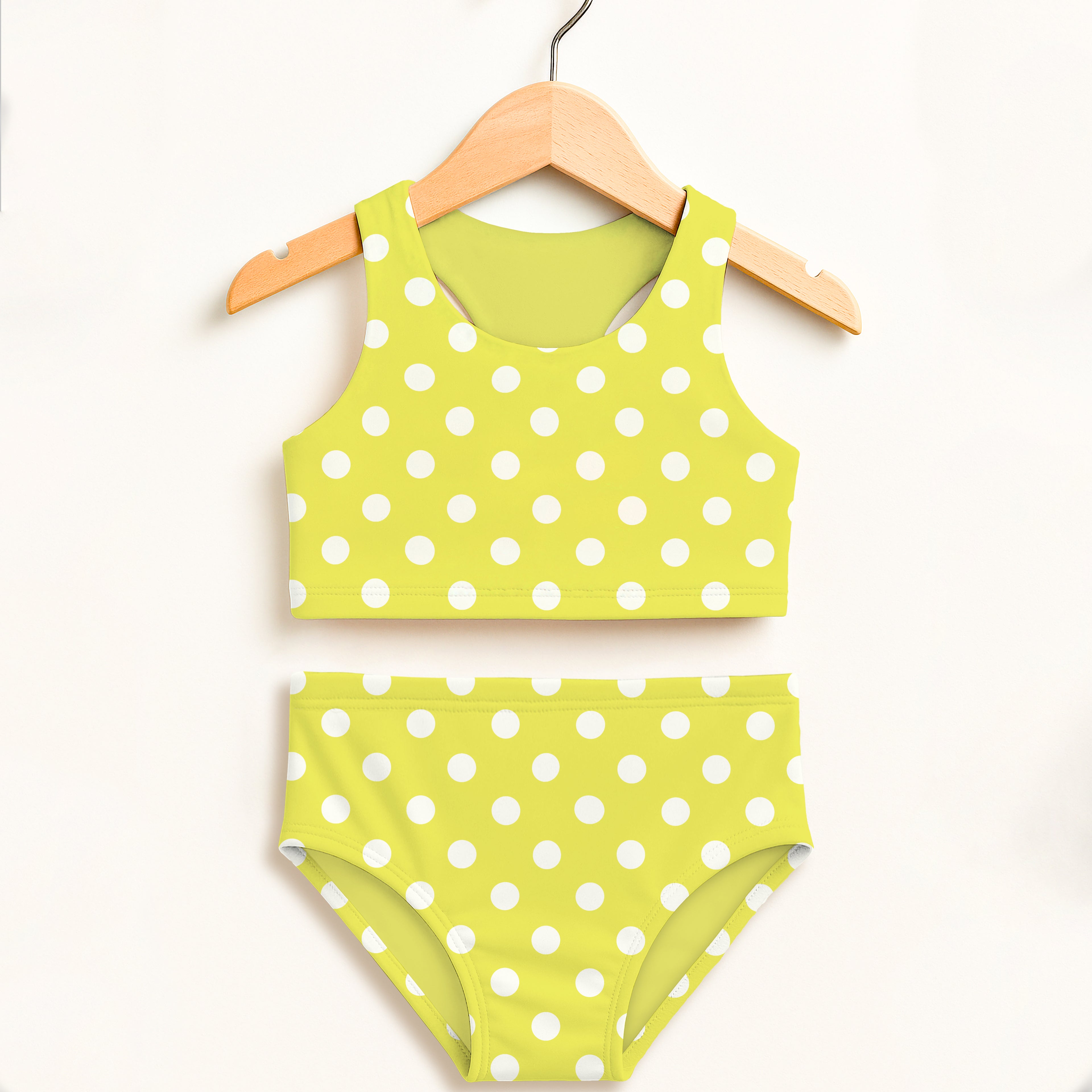 Girls yellow polka dot two piece swimsuit with halter top and high waisted bottoms in bright lime green with white dots